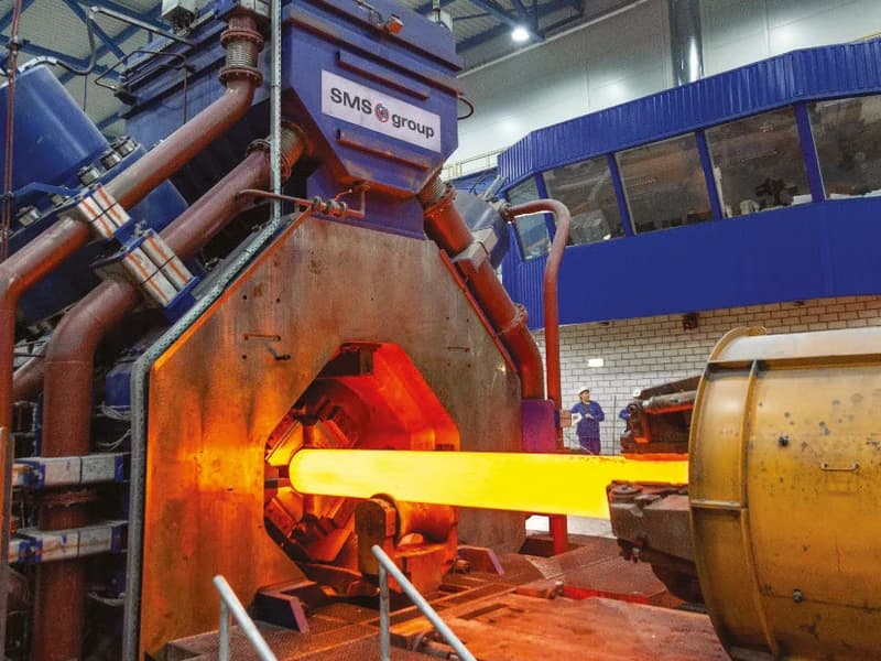 SMS Group hydraulic radial forging press working a glowing hot billet