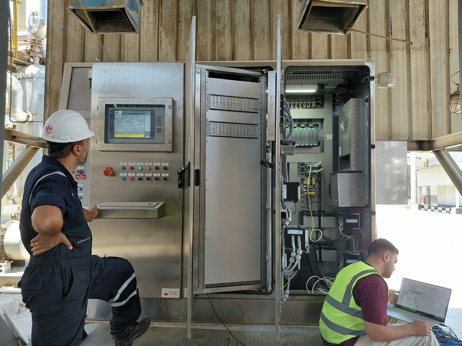 Engineers working at the open Ex p turbomachinery control panel during commissioning at CORC